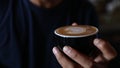 Barrista is making heart latte art on cappuccino.