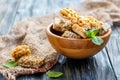 Bars of honey with peanuts, seeds and sesame in a wooden bowl. Royalty Free Stock Photo