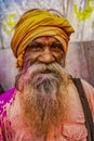 Barsana, India - February 23, 2018 - Old man with grey beard and yellow turbin rests in Holi festival Royalty Free Stock Photo