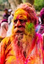 Old man with grey beard covered in Holi paint colors Royalty Free Stock Photo