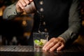 Bartender adding cane sugar into the cocktail glass. Process of Royalty Free Stock Photo