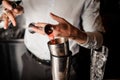 Bartender adding a red alcoholic drink into the steel shaker Royalty Free Stock Photo