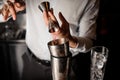 Bartender adding a transparent red alcoholic drink into the steel shaker Royalty Free Stock Photo