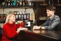 Bartender and blonde girl drink white and red Royalty Free Stock Photo