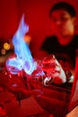 Bartender burning Sambuca at the bar Royalty Free Stock Photo