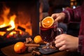 bartender cloaking a glass of mulled wine with a fiery hollowed orange slice