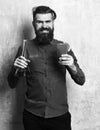 Bartender with a cocktail. Brutal hipster holding alcoholic shot and glass tube or flask Royalty Free Stock Photo