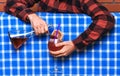 Bartender concept. Male hands holding bottle, pouring glass, making alcoholic cocktail. Man in checkered shirt, faceless Royalty Free Stock Photo