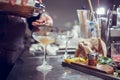 Bartender coocks cocktail behind a bar counter Royalty Free Stock Photo
