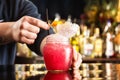 Bartender is decorating red cocktail in jar with frappe at bar Royalty Free Stock Photo