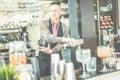 Bartender doing flair inside cruise american bar - Barman at work performing freestyle with bottle and shaker - Focus on man face Royalty Free Stock Photo