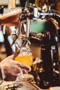 Bartender filling beer from tap at bar Royalty Free Stock Photo