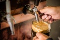 Bartender filling up with craft beer a pint glass Royalty Free Stock Photo