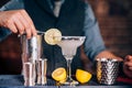 Bartender garnishing drink, pouring lime margarita in fancy glass at restaurant Royalty Free Stock Photo