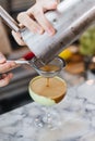 Bartender gently pour coffee mix with alcohol pass the filter in wine glass with green paste for making cocktail Royalty Free Stock Photo