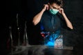 Young bartender behind bar puts on medical mask.