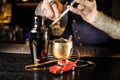 Bartender grating nutmeg to the cocktail in the copper cup Royalty Free Stock Photo