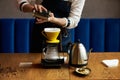 Barista pouring water on coffee ground with paper filter Royalty Free Stock Photo