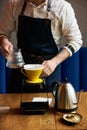 Barista pouring water on coffee ground with paper filter Royalty Free Stock Photo