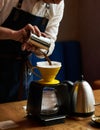 Barista pouring water on coffee ground with paper filter Royalty Free Stock Photo