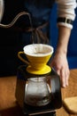 Barista pouring water on coffee ground with paper filter Royalty Free Stock Photo