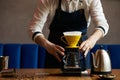 Barista pouring water on coffee ground with paper filter Royalty Free Stock Photo