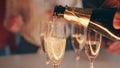 Bartender hand pouring champagne glasses at terrace closeup. Friends toasting Royalty Free Stock Photo