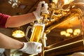 Bartender hands pouring light  beer in a glass Royalty Free Stock Photo