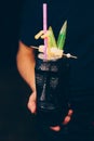 Bartender holding Cocktail near utensil strainer healthy drink on a bar counter . Professional view . Trendy stylish alcoholic