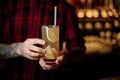 Bartender holding a glass of fresh alcoholic orange cocktail Royalty Free Stock Photo