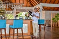 Bartender with huge bottle of alcohol