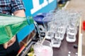 A bartender makes a cocktail over the outdoor bar counter