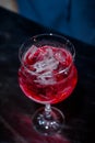 The bartender makes a red cocktail. Blue dark background Royalty Free Stock Photo