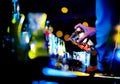 Bartender making alcohol cocktail at bar counter at nightclub, barman is making cocktail