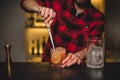 Bartender making and decorating cocktail close-up