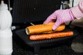 Bartender making french hot dog on grill Royalty Free Stock Photo