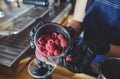 Bartender making mojito cocktail. Process of bartending in bar.Raspberry - ingredient for drinks in nightclub