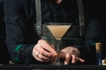 Bartender making relaxing cocktail on a bar background Royalty Free Stock Photo