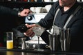 Bartender making relaxing coctail on a bar background Royalty Free Stock Photo
