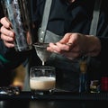 Bartender making relaxing coctail on a bar background Royalty Free Stock Photo