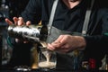 Bartender making relaxing coctail on a bar background Royalty Free Stock Photo