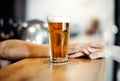 Bartender man gives beer glass to a customer. Royalty Free Stock Photo