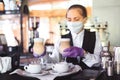 Bartender in medical mask and gloves makes latte coffee