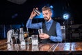 Barman makes a cocktail on the porterhouse