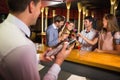 Bartender mixing up a cocktail for customers