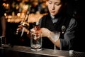 Bartender pouring an alcohol cocktail with jigger Royalty Free Stock Photo
