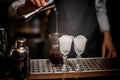 Bartender pouring alcoholic drink into the glass for making fresh summer cocktails Royalty Free Stock Photo