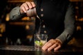 Bartender pouring cane sugar into the cocktail glass Royalty Free Stock Photo