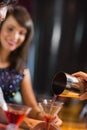 Bartender pouring cocktail for customers Royalty Free Stock Photo