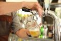 Bartender pouring cold beer from tap, closeup Royalty Free Stock Photo